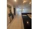 Well-lit kitchen with a built-in wine fridge, bar, and modern fixtures at 8111 Lakewood Main St # 207, Lakewood Ranch, FL 34202