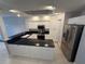 Kitchen featuring large island with sink, stainless steel appliances and white cabinetry at 8111 Lakewood Main St # 207, Lakewood Ranch, FL 34202