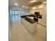 Open kitchen with island, stainless steel appliances, and view to living area at 8111 Lakewood Main St # 207, Lakewood Ranch, FL 34202