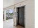 Elevator on a landing with view to the outside at 840 Virginia St # 202, Dunedin, FL 34698