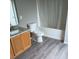 Clean bathroom featuring a shower-tub combo, granite countertop, and vinyl flooring at 6339 Magnolia Trails Ln, Gibsonton, FL 33534