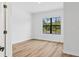 A well-lit bedroom features wood-look floors and a large window with green exterior view at 1268 Impala St, North Port, FL 34288