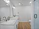 Bathroom featuring double sinks, granite countertop, and tiled walk-in shower at 3010 Pine Club Dr, Plant City, FL 33566