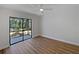 Bright bedroom with wood-look floors, ceiling fan, and sliding glass doors to the outside at 3010 Pine Club Dr, Plant City, FL 33566