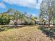 Inviting home with lush landscaping and mature trees creating a serene setting at 3010 Pine Club Dr, Plant City, FL 33566