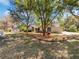 Beautiful home with mature trees, manicured lawn, and inviting curb appeal at 3010 Pine Club Dr, Plant City, FL 33566