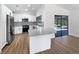 Bright kitchen boasts white cabinets, granite counters, stainless appliances, and opens to the lanai at 3010 Pine Club Dr, Plant City, FL 33566