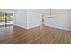 Spacious living area featuring luxury vinyl plank flooring, neutral walls, and modern light fixture at 3010 Pine Club Dr, Plant City, FL 33566