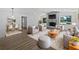 Bright living room showcasing a fireplace, modern furniture, and an adjacent dining area with stylish decor at 3010 Pine Club Dr, Plant City, FL 33566