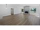 Open living room with a fireplace, light-colored walls, and wood-look floors at 3010 Pine Club Dr, Plant City, FL 33566