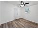 This bright bedroom features wood-look floors, a ceiling fan, and natural light from the window at 3116 Karen Ave, Largo, FL 33774