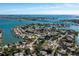 A picturesque aerial view of a waterfront neighborhood showcasing homes with boating access to the shimmering blue waters at 3962 Poinsettia Dr, St Pete Beach, FL 33706