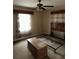 Bedroom with large window, ceiling fan, and basic furnishing of a headboard and dresser on carpeted floor at 4427 20Th N St, St Petersburg, FL 33714