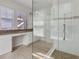 Bathroom featuring a large walk-in shower with glass door and a vanity area at 5954 Caldera Ridge Dr, Lithia, FL 33547