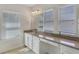 Bathroom featuring vanity area, granite countertop, and large windows at 5954 Caldera Ridge Dr, Lithia, FL 33547