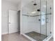 Modern bathroom with a glass-enclosed shower, tiled walls, and a rainfall showerhead for a spa-like experience at 5954 Caldera Ridge Dr, Lithia, FL 33547