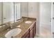 Bathroom with double sink vanity, granite countertop, and shower/tub combination at 5954 Caldera Ridge Dr, Lithia, FL 33547