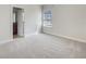 Bright bedroom featuring neutral walls, carpet, window with blinds, and an ensuite bathroom at 5954 Caldera Ridge Dr, Lithia, FL 33547