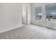 Empty bedroom with carpet, two large windows, and a door frame at 5954 Caldera Ridge Dr, Lithia, FL 33547