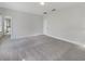 Large open bedroom features neutral carpet, ample space, and a view of an adjacent room through an open doorway at 5954 Caldera Ridge Dr, Lithia, FL 33547