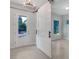Entryway has a pendant light and sliding door leading into an open room with a window at 5954 Caldera Ridge Dr, Lithia, FL 33547