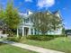 Two-story home with well-kept lawn, mature trees, and sidewalk at 5954 Caldera Ridge Dr, Lithia, FL 33547