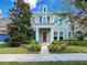 Beautiful two story home with a red door, dormer window, and lush landscaping at 5954 Caldera Ridge Dr, Lithia, FL 33547