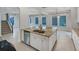 Kitchen island boasts a stainless steel sink, granite countertops, and ample storage space at 5954 Caldera Ridge Dr, Lithia, FL 33547