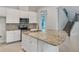 Bright kitchen features granite countertops, stainless appliances, white cabinets, and a stylish backsplash at 5954 Caldera Ridge Dr, Lithia, FL 33547