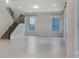 Spacious living room featuring tile floors, staircase, and large windows at 5954 Caldera Ridge Dr, Lithia, FL 33547