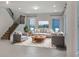 Inviting living room with a staircase, comfortable seating, large rug, and scenic views at 5954 Caldera Ridge Dr, Lithia, FL 33547