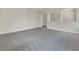 Open living area features carpet, white walls, and arched doorways at 5954 Caldera Ridge Dr, Lithia, FL 33547