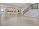 Open-concept floor plan features tile floors, white walls, a staircase, and sightlines to the kitchen at 5954 Caldera Ridge Dr, Lithia, FL 33547