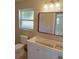 Bathroom featuring vanity with drawers, toilet, and a large mirror at 7620 Judith Cres, Port Richey, FL 34668