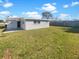 Wide open backyard space featuring a well manicured lawn and concrete deck at 8340 75Th Pl, Seminole, FL 33777