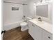 Clean bathroom with new fixtures, white tile, and wood-look flooring at 8340 75Th Pl, Seminole, FL 33777