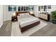 Modern bedroom with a plush rug, and a stylish dresser below a window with black blinds at 8340 75Th Pl, Seminole, FL 33777