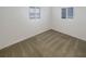 Neutral bedroom featuring two windows and carpet at 8340 75Th Pl, Seminole, FL 33777