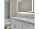 A vanity with a white countertop, cabinets, and a well lit mirror at 15741 Autry Cir, Port Charlotte, FL 33981