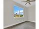 Bright bedroom features hardwood floors and large windows with beautiful outdoor views at 15741 Autry Cir, Port Charlotte, FL 33981