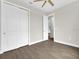 An interior shot showcases a bedroom with wood floors, a fan, and a closet at 15741 Autry Cir, Port Charlotte, FL 33981