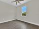 An interior shot showcases a bedroom with wood floors, a fan, and a window at 15741 Autry Cir, Port Charlotte, FL 33981