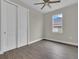 An interior shot showcases a bedroom with wood floors, a fan, and a window at 15741 Autry Cir, Port Charlotte, FL 33981