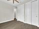 An interior shot showcases a bedroom with wood floors, a fan, and a closet at 15741 Autry Cir, Port Charlotte, FL 33981