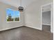 Spacious dining room features hardwood floors, large windows, and modern chandelier at 15741 Autry Cir, Port Charlotte, FL 33981