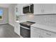Updated kitchen with modern appliances and a white subway tile backsplash at 15741 Autry Cir, Port Charlotte, FL 33981