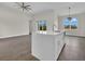 Kitchen with an island featuring a sink and modern pendant lighting fixture at 15741 Autry Cir, Port Charlotte, FL 33981