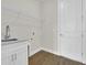 Bright laundry room features granite counters, white cabinetry, shelving, and hardwood floors at 15741 Autry Cir, Port Charlotte, FL 33981