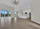 Bright, open-concept living space features wood-look tile and sliding glass doors at 15741 Autry Cir, Port Charlotte, FL 33981
