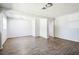 Clean living room features wood-look flooring and flows to adjacent areas within the home at 1907 Lakewood Dr, Clearwater, FL 33763